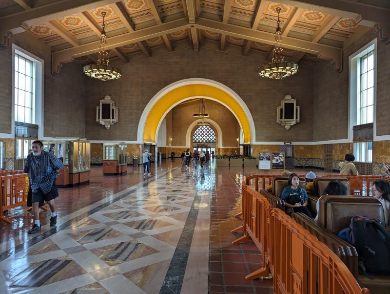 The inside of Los Angeles Union station, with vaulted roof, chandeliers, and some art deco paint on the ceiling