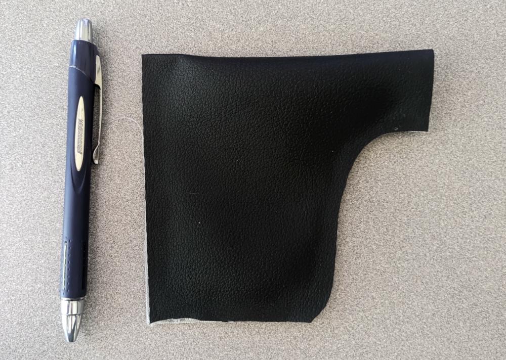 a tiny uilleann pipe bag, about as tall as a ballpoint pen